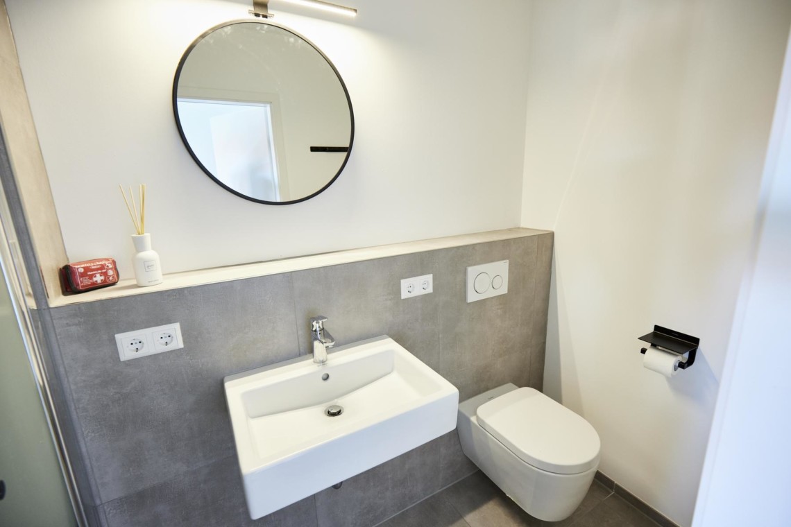 Moderner Ferienwohnungs-Badezimmer in Bad Wiessee mit stylischer Ausstattung. Buchen Sie jetzt Ihren Aufenthalt bei stayFritz.