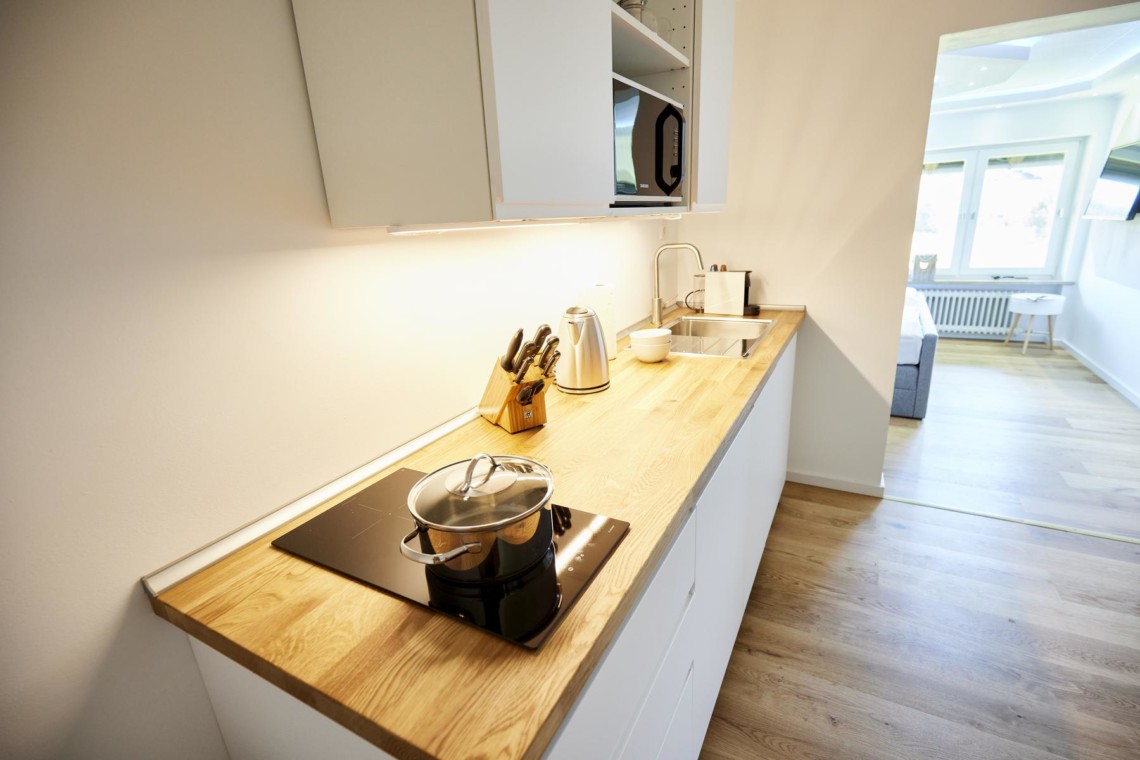 Moderne Küchenzeile in heller Ferienwohnung am Tegernsee. Komfort & Stil in Bad Wiessee. Ideal für Paare. Buchen Sie jetzt Ihre Auszeit!