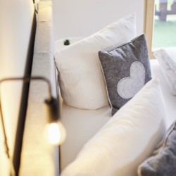 Gemütliches Studio in Bad Wiessee mit bequemen Kissen und warmem Licht. Ideal für einen entspannenden Urlaub am Tegernsee.