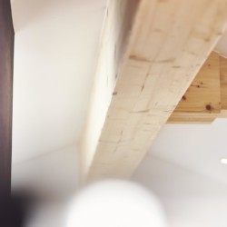 Holzverkleidete Dachschrägen in einem stilvollen Penthouse in Bad Wiessee – ideal für eine gemütliche Auszeit.