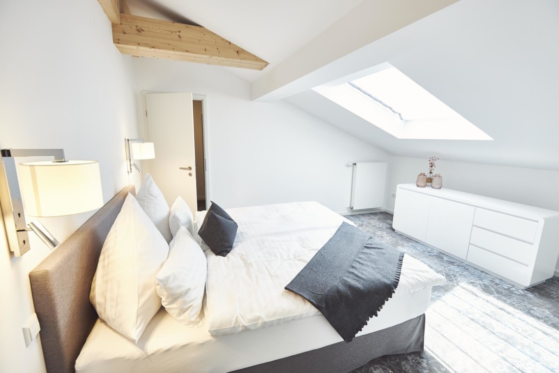 Elegantes Alpen-Penthouse in Bad Wiessee mit gemütlichem Schlafzimmer. Modernes Design für perfekten Urlaub. #stayFritz #BadWiessee