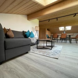 Gemütliches Penthouse in Bad Wiessee mit Holzdecken, stilvollem Interieur und modernem Komfort.