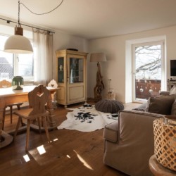 Gemütlicher Wohnraum mit Holzboden, Seeblick, in Tegernsee, ideal für Entspannung und bayrischen Flair.