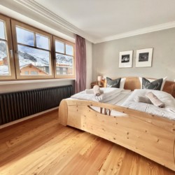 Gemütliches Schlafzimmer mit Bergblick in Warth am Arlberg, ideal für den Skiurlaub.