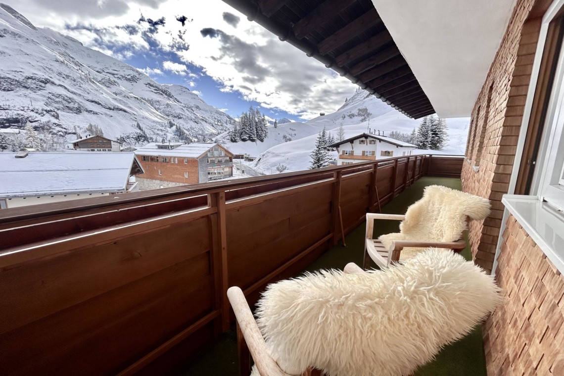 Gemütlicher Balkon, Blick auf verschneite Berge in Warth am Arlberg. Ideal für Entspannung nach dem Skifahren.