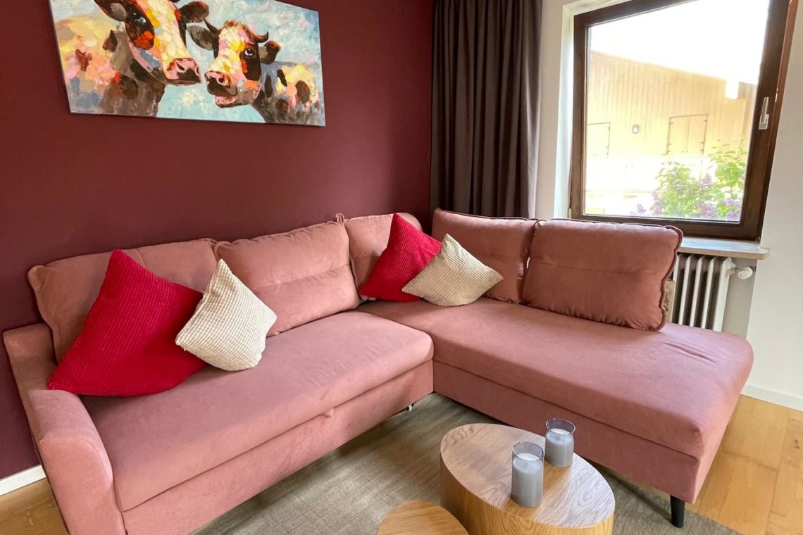 Gemütliches Apartment am Tegernsee mit eleganter Couch, modernem Dekor und einladender Atmosphäre. Ideal für Urlaub im Tegernseegebiet.