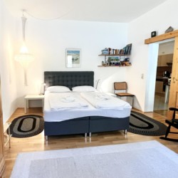 Gemütliche Ferienwohnung in Schliersee mit komfortablem Bett, einladendem Design und Holzelementen. Ideal für Entspannung nach dem Wandern.