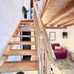 Gemütliche Dachwohnung in Bad Wiessee mit Holztreppe, moderner Einrichtung und WLAN.