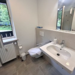 Helles Badezimmer in Ferienwohnung mit Naturblick, sauber und modern für entspannenden Urlaub.