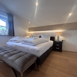 Gemütliches, helles Schlafzimmer mit großem Bett & moderner Einrichtung in Ferienwohnung "Krainsbergkogel".