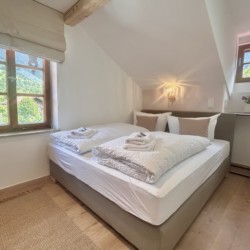 Helles, gemütliches Schlafzimmer mit Bergblick, ideal für die Suche nach Ruhe und Komfort.