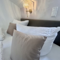 Gemütliches Schlafzimmer in Ferienwohnung "Mitterberg" mit elegantem Design und moderner Beleuchtung für einen erholsamen Urlaub.