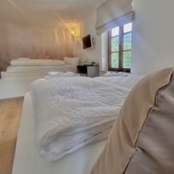 Gemütliches Schlafzimmer in Ferienwohnung mit Holzelementen und modernem Design, ideal für entspannten Urlaub.